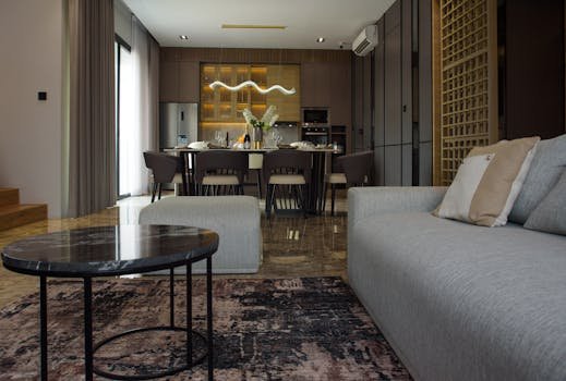 Spacious modern dining and living area with stylish furniture and elegant decor.